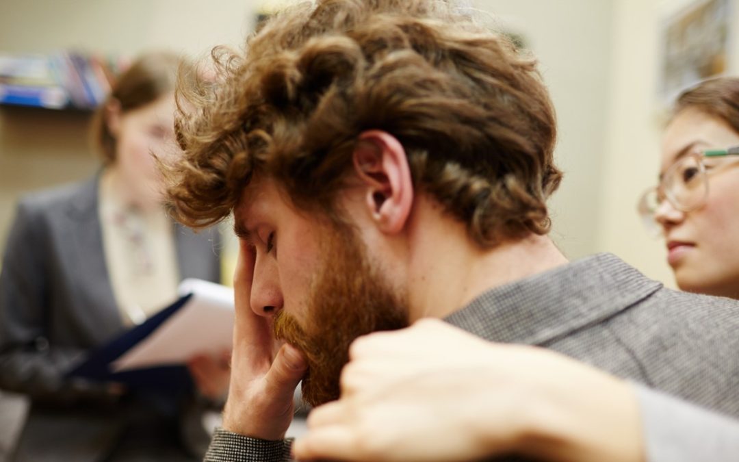 Sad man being comforted.